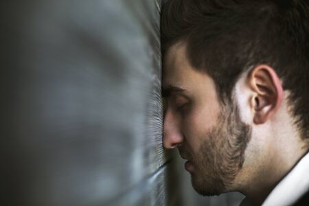 Closeup of handsome businessman's head against wooden wall. Side view, Copy space