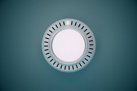 Rotating silver knob button on grey background. 3D Rendering