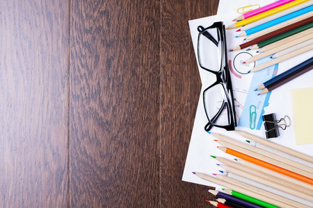 Top view of office desktop with colorful stationery items and glasses. Mock upの写真素材