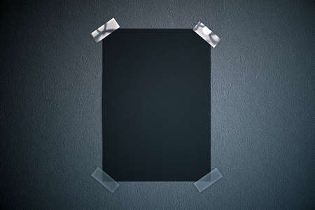 Black paper sheet taped to dark background. Mock up, 3D Renderingの写真素材