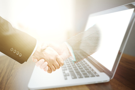 Businessman shaking hand with virtual partner. Online business conceptの写真素材