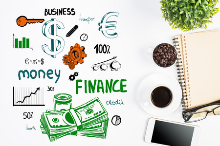Top view of white office desktop with creative finance sketching, coffee cup, blank smartphone and other items. Financial growth conceptの写真素材