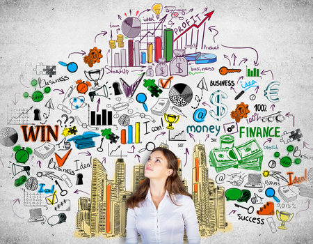 Attractive daydreaming girl on concrete background with creative business sketch. Success conceptの写真素材