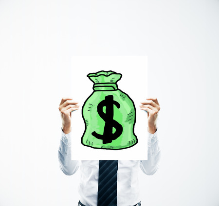 Businessman hands holding poster with creative green money bag sketch. Financial growth conceptの写真素材