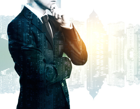 Thoughtful businessman on bright city background with copy space. research concept. Double exposureの写真素材