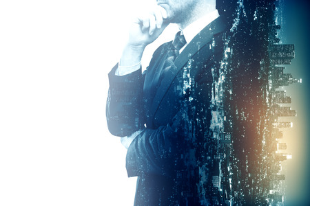 Side view of thoughtful businessman on city background. Double exposure.の写真素材