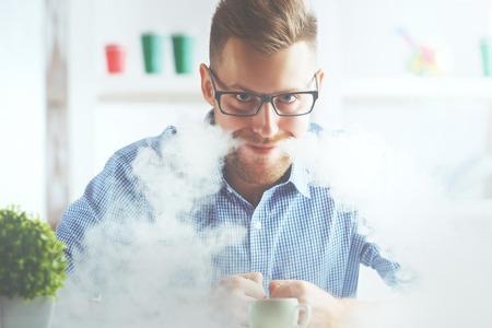 Portrait of crazy man letting smoke out of mouth.の写真素材