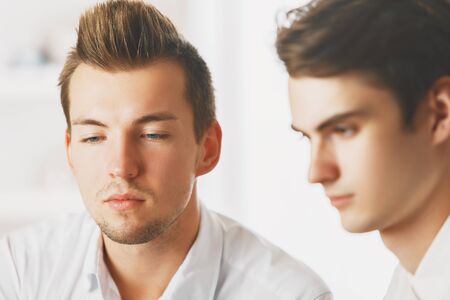 Portrait of two attractive caucasian males at workplace. Teamwork conceptの写真素材