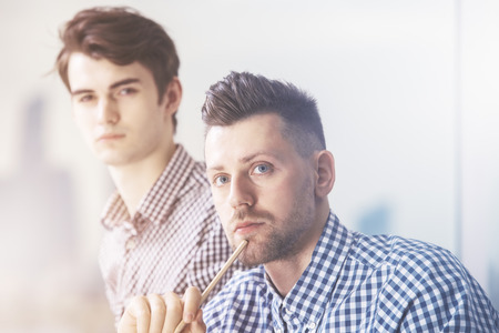 Close up portrait of two attractive european businessmenの写真素材