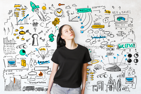 Thoughtful caucasian woman on white background with creative business sketch. Success conceptの写真素材