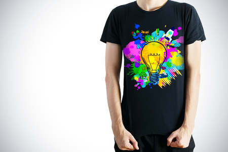 Guy in black shirt with colorful rocket print. Creative startup ideasの写真素材
