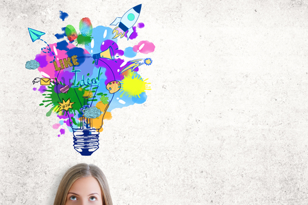 Portrait of attractive caucasian woman with colorful lamp sketch on concrete background. Creative ideas conceptの写真素材