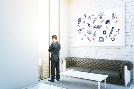 Thoughtful businessman in interior with city view, leather sofa, coffee table and education icons in frame. Knowledge concept. 3D Renderingの写真素材