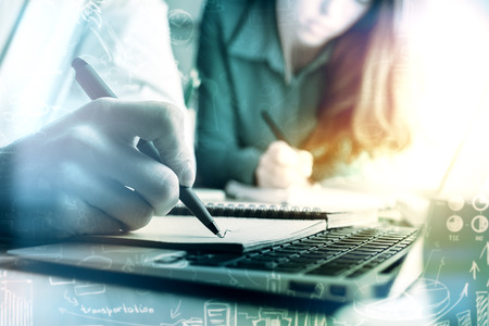 Businesspeople working on project at workpkace with business charts. Filtered image. Accounting conceptの写真素材