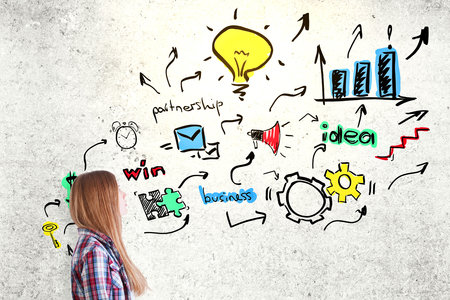 Pretty caucasian woman with business sketch on concrete background. Success conceptの写真素材