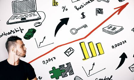 Young man on white background with drawn business icons. Entrepreneurship conceptの写真素材