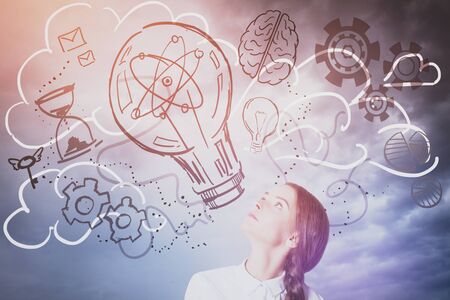 Pretty caucasian lady looking up at abstract lamp, cogs and brain sketch. Sky background. Creative...