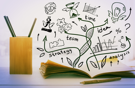 Close up of workplace with supplies and abstract business sketch. Research conceptの写真素材