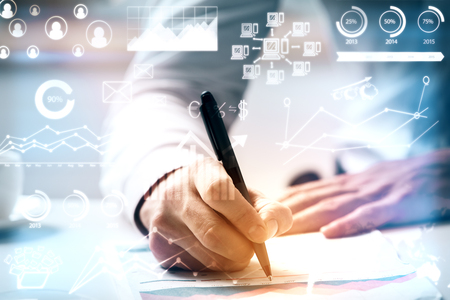 Man doing paperwork. Close up with abstract business charts and diagrams.  Accountant conceptの写真素材