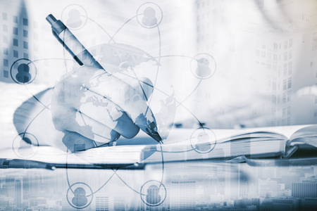 Close up of male hand writing in open notepad on abstract city background with globe and connected people icons. HR conceptの写真素材