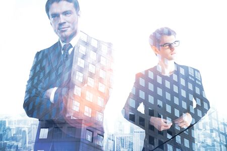 Two handsome businessmen on creative city background. Double exposure. Employment conceptの写真素材