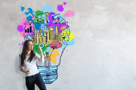 Happy young woman with colorful sketch on concrete background. Creative idea conceptの写真素材