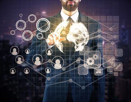 Businessman pointing at globe with HR  and business icons. Human resources conceptの写真素材
