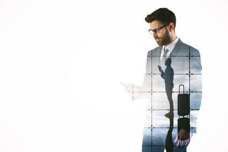 Attractive young bearded man using mobile phone on abstract airport background. Traveling concept. Double exposureの写真素材