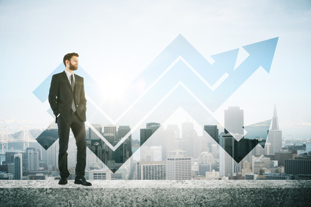 Man on concrete roof top with arrows. City background. Success conceptの写真素材