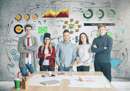 Attractive young european team standing in office with creative business sketch. Partnership conceptの写真素材