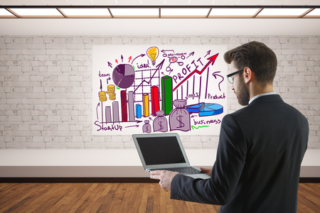 Young businessman using empty laptop in interior with sketch. Online business concept. 3D Renderingの写真素材