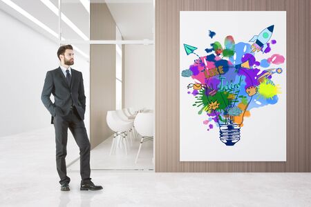 Young businessman in suit standing in modern conference interior with colorful sketch. Creative startup concept. 3D Renderingの写真素材