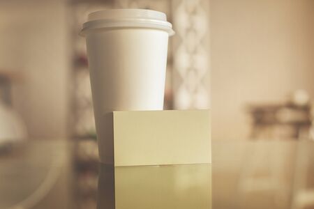 Close up of take out coffee cup and empty business card. Mock upの写真素材