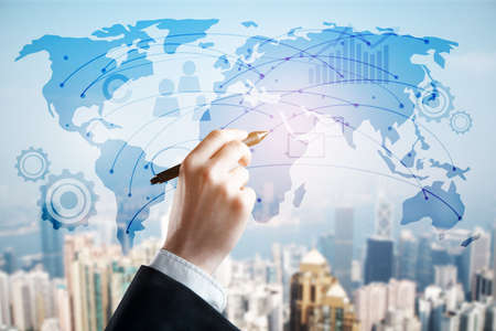 Male hand drawing abstract digital map on city background. Online business concept