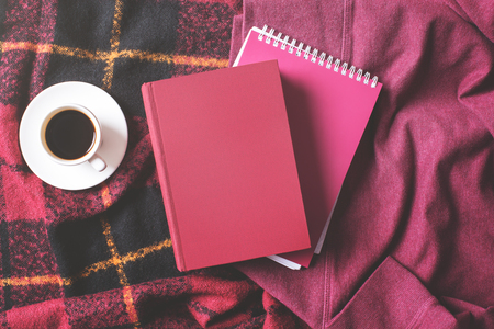 Top view of hardcover book, notepad, coffee cup, beans and checkered plaid. Leisure conceptの写真素材