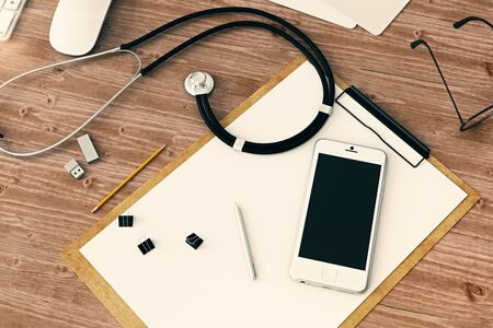 Top view of wooden doctor's workplace with empty smartphone, paperwork, stethoscope and other items. Mock up, 3D Renderingの写真素材