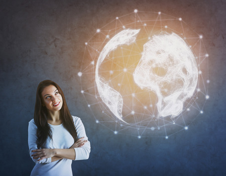Cheerful young woman standing on concrete background with glowing polygonal globe. Infograph concept. 3D Renderingの写真素材