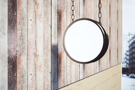 Empty circular stopper handing on wooden building in bright city. Ad concept. Mock up, 3D Renderingの写真素材
