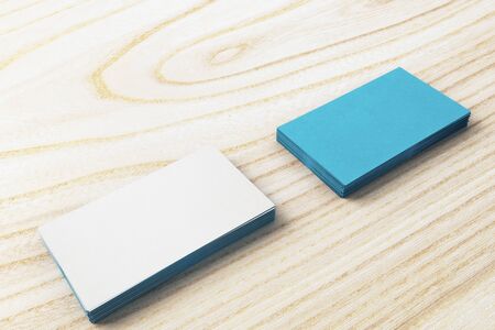 Empty business card stacks on wooden desktop. Info concept. Mock up, 3D Renderingの写真素材