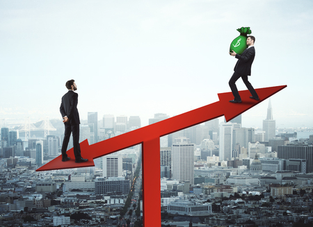 Businessmen with green dollar bag standing on red chart arrow scales on city background. Income and sales concept. 3D Renderingの写真素材