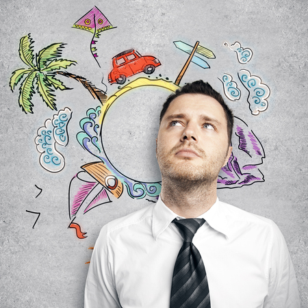 Thoughtful young businessman on concrete background with vacation sketch. Business trip conceptの写真素材