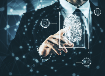 Businessman pressing abstract fingerprint interface on blurry background. Identification concept. Double exposureの写真素材