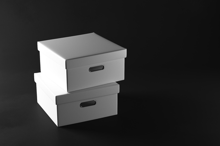 Stacks of white boxes on dark background. Packaging concept. 3D Rendering