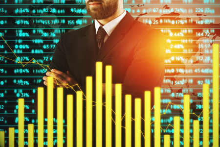 Businessman with folded arms standing on abstract background with digital business chart bars. Forex, economy and success conceptg. Double exposureの写真素材