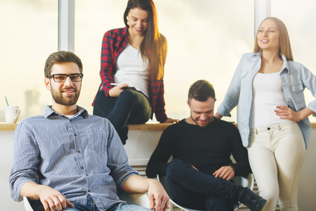 Young white people team members uisng cellphone at hipster workplace. Technology and communication conceptの写真素材