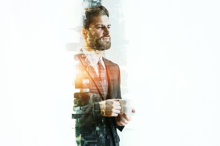 Handsome businessman drinking coffee on abstract white city background. Lifestyle concept. Double exposureの写真素材
