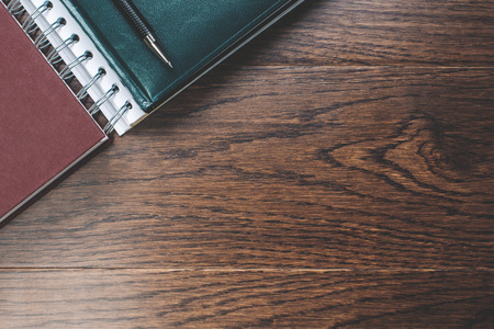 Top view and close up of empty dark wooden desk top with supplies. Workplace concept. Mock upの写真素材