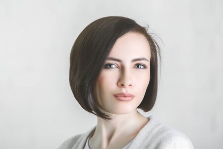 Close up portrait of white woman on gray background. Headshot conceptの写真素材