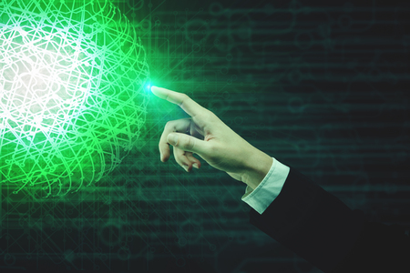 Businessman hand pointing at abstract glowing green polygonal sphere on digital background. Technology and global business concept. 3D Renderingの写真素材