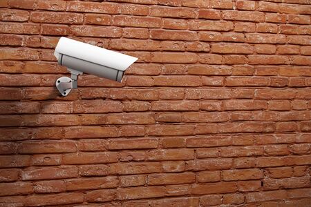 White CCTV camera on red brick wall background with copyspace. Monitor concept. 3D Rendering